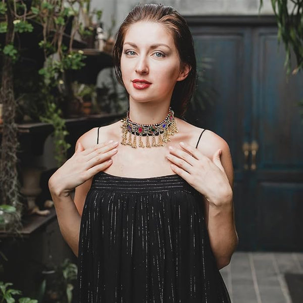 Handcrafted Afghan tribal necklace featuring antique hammered metalwork and colorful beads.
