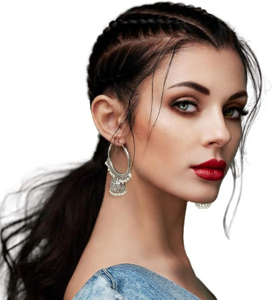 Close-up of the secure infinity hoop closure on a pair of pearl-adorned Indian jhumka earrings.
