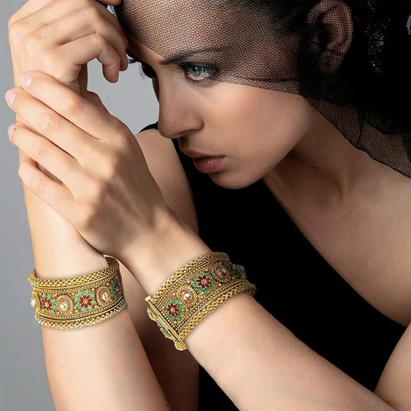 Close-up of vibrant red-green enamel and sparkling Polki-style cubic zircon stones on gold.