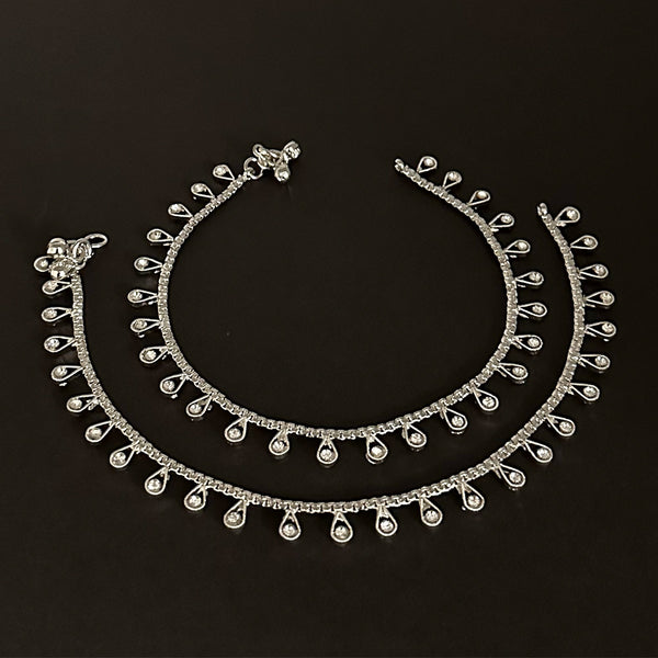 Gift-ready silver rhinestone anklets presented in a signature burgundy velvet storage pouch.
