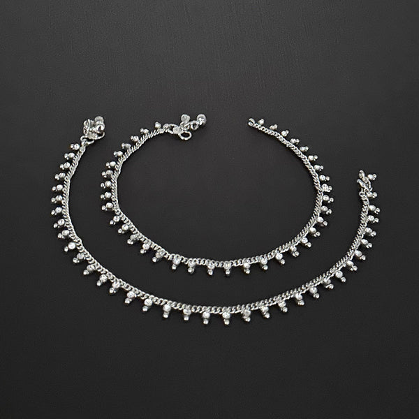 Gift-ready silver rhinestone anklets presented in a signature burgundy velvet storage pouch.
