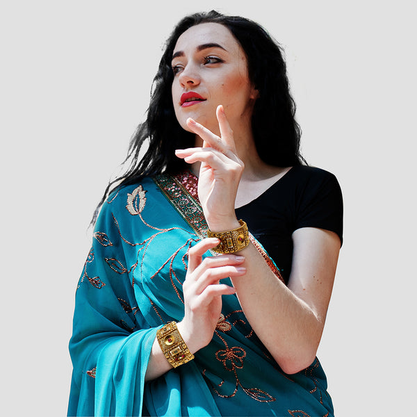 
Gold-plated Rajwada openable kada bangle pair with green meenakari flowers and red zircon stones.
