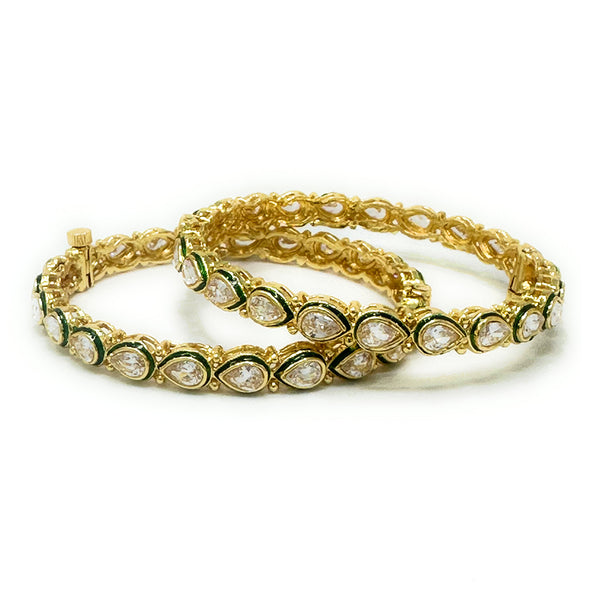 Model wearing gold-plated green enamel teardrop Kundan bangles; Indian bridal jewellery.

