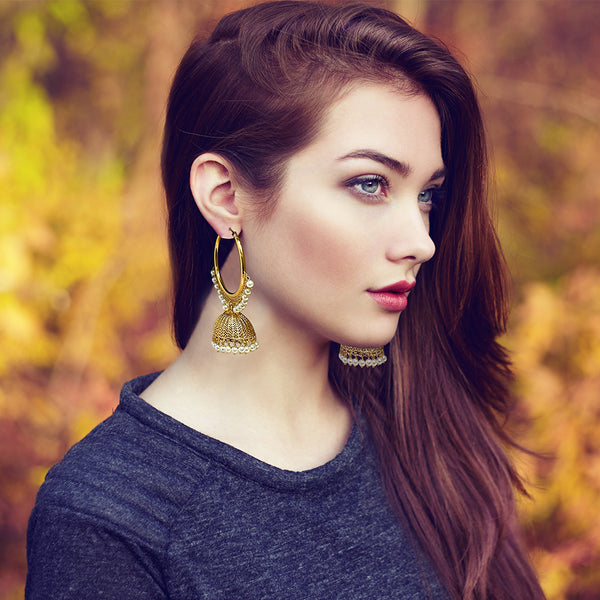 Handcrafted gold-tone filigree jhumka dangles with shimmering cubic zircon and delicate pearl beads.
