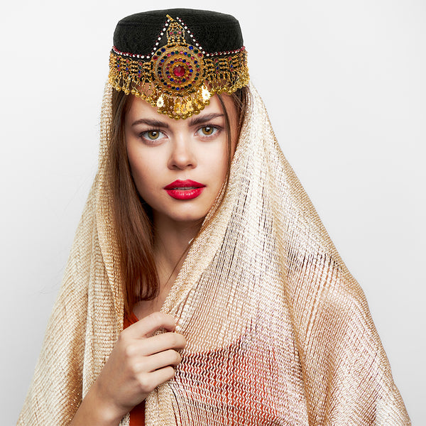 Top view of Turkish tribal hat highlighting gold chains, stones, and medallion centerpiece