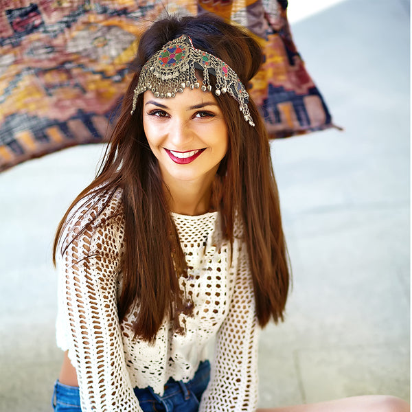 Belly dance costume headpiece with multicolor stones and ethnic metalwork for performances.
