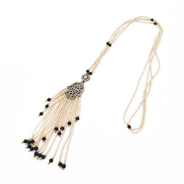 Gift-ready Hamsa Hand pearl necklace presented in a premium burgundy velvet pouch.
